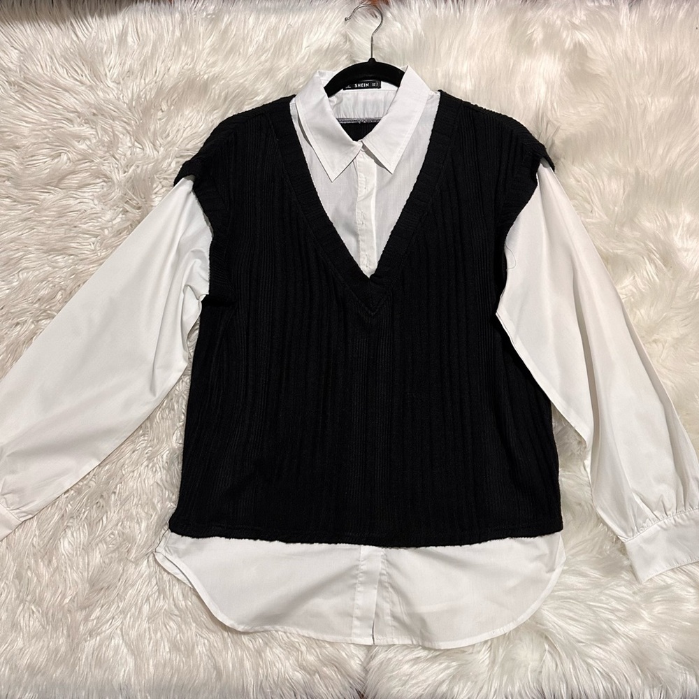 Black sweater vest with button down white shirt